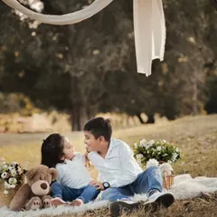 A sweet, candid moment between a brother and sister during an outdoor picnic shoot. We create a relaxed environment where kids can just be themselves, allowing us to capture their natural bond.