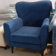 This plush blue velvet armchair is an example of our bespoke furniture, ready to be delivered to a client. We customize fabric, color, and design to your preference.