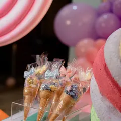 Sweet treats as part of the decor. These ice cream cone-shaped party favors add to the whimsical atmosphere of a Candyland party.