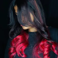 We encourage our students to explore their creativity with bold hair color. This vibrant red ombre look, created during a student hair lab, showcases advanced color application and blending skills for a stunning, head-turning result.