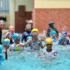 A snapshot of the energy and fun from one of our regular swimming classes. You can see our coaches right in the water with the kids, making a splash and learning together.