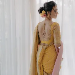 A view of the intricate hairstyle and back of the blouse, showing the complete bridal look.