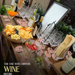 A close-up of my wine and cheese station, perfect for guests who appreciate the finer things. The setup includes a variety of cheeses, crackers, grapes, and of course, a selection of fine wines.
