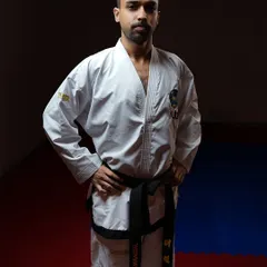 A powerful stance in my Taekwon-Do uniform. The goal is to be unstoppable, not through brute force, but through unwavering self-belief and the discipline to see things through.