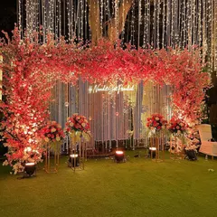 A stunning cherry blossom themed backdrop. We used shades of pink and red, along with a custom neon hashtag, to create this vibrant and modern photo-op for an engagement.