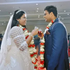 The wedding toast. A happy couple raises their glasses during their reception, a classic moment of celebration.