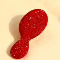 A gift that's both practical and glamorous. This sparkling red crystal-studded hairbrush is a unique and thoughtful present for the person who has everything.