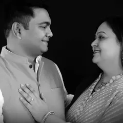 A gentle, candid moment between a couple, captured in black and white. The simple studio setting removes distractions and puts the focus entirely on your connection.