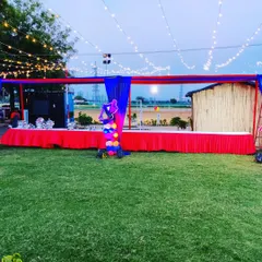 For outdoor birthday parties, we set up extensive buffet counters. This long table is draped in red and blue fabric to match the Spiderman theme, with string lights overhead for evening ambiance.