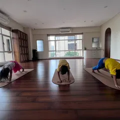 Nurturing mind, body, and spirit with our engaging and playful kids' yoga classes. Here they are, finding their inner puppy in Downward Dog.