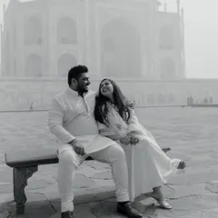 A joyful black and white portrait at the Taj Mahal. This candid shot captures the couple's happiness and easy chemistry, with the majestic monument providing a timeless backdrop.