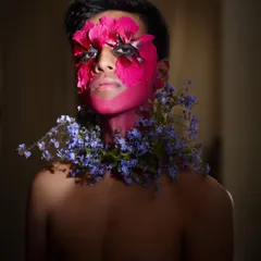 This is from an editorial concept where we explored the fusion of nature and identity. Working with a talented makeup artist, we used fresh flowers and bold color to create a piece of living art, pushing the boundaries of a typical portrait.