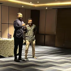 Sharing a laugh with a volunteer during an intimate corporate gathering. The best part of close-up magic is the direct interaction and seeing the look of astonishment on someone's face.