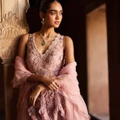 A close-up on the intricate embroidery and delicate organza dupatta. I paired this pink ensemble with a simple emerald necklace to add a pop of contrasting color, drawing attention to the neckline.