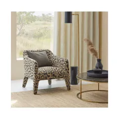 This armchair, upholstered in a bold geometric 'Hiraani' fabric, becomes the focal point of the room. I often suggest a single, statement piece of furniture to anchor a space and express a client's personality.