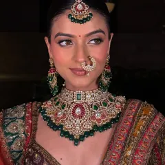 Another beautiful angle of this classic bridal look. The maang tikka and nath complete the ensemble, providing great inspiration for wedding makeup artists.