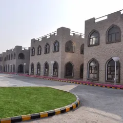 A perspective view of the Aligarh Muslim University factory complex. The design features repeating architectural bays with arched windows, creating a sense of rhythm and grandeur across the facade while honoring traditional Islamic design principles.