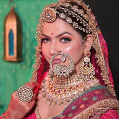 Mastering traditional bridal hairstyling is a key to success. This Rajasthani bridal look showcases intricate hair work, including the placement of a traditional matha patti and a heavily jeweled nath, complementing the overall regal aesthetic.