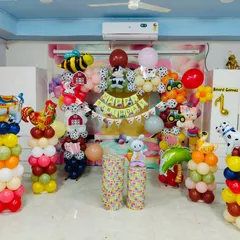 A classic farm animal theme, perfect for younger children. This setup includes balloon sculptures of a cow, pig, and chicken, along with a barnyard backdrop.