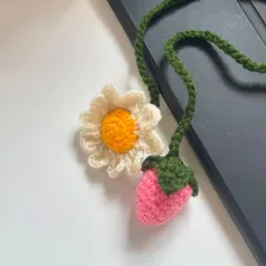 A whimsical combination of a daisy and a strawberry, this bag charm is a unique and playful accessory for anyone who loves cute, handmade items.