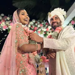 The pure joy of a beach wedding. This happy couple, framed by a beautiful floral arch, perfectly captures the relaxed and celebratory spirit of a Goa wedding.