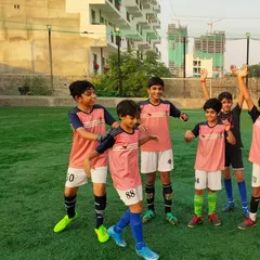 The bonds of friendship are just as important as the skills we learn. Our players enjoying a lighthearted moment together on the field.