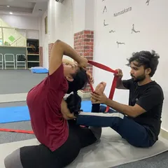 In our teacher training, I provide hands-on adjustments to help you find the correct alignment and deepen your postures safely. Here, I am assisting a student in Rajakapotasana (King Pigeon Pose) using a strap to gently open the shoulders and deepen the backbend.