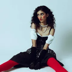 A full shot of a dramatic, doll-like makeup look created for a test shoot. The exaggerated blush and expressive eyes are key elements of this creative concept.