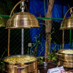 Our stunning brass serveware with elegant cloche lids, keeping the food warm while adding a touch of royalty to the buffet line.