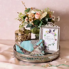 The Silver Oasis Rakhi Hamper is presented on this elegant silver tray, which can be reused as a beautiful piece of home decor.