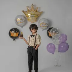 This young man is ready to celebrate his 5th birthday in style. I use props like crown balloons and a mini cake to add a special touch to milestone photos.