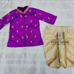 A twinning set for a brother and sister. The newborn girl's Pattu Pavadai is perfectly coordinated with her brother's purple kurta and dhoti.
