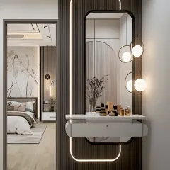 A stylish and functional dressing nook created in a hallway. The design features a floating console with a drawer, a large mirror with integrated lighting, and a dark fluted panel for a touch of modern elegance.
