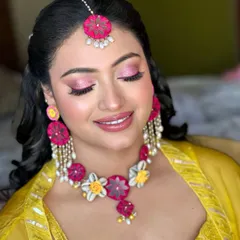 A close-up of the soft pink Haldi makeup. The shimmering pink eyeshadow and matching lip color create a harmonious and radiant look that is perfect for a daytime celebration.