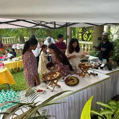 Guests gathering around the food station at a recent birthday brunch. I design the layout to be inviting and easy for both children and adults to navigate.