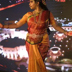 A three-quarter view of the Draupadi look, showing the traditional costume and jewellery. The makeup complements the rich colors of the saree and is designed for durability throughout the performance.