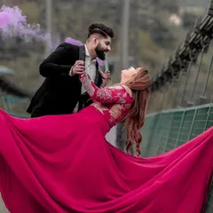 A magical moment captured on a suspension bridge in Rishikesh. The couple shares a dance as purple smoke adds a touch of drama, creating a truly cinematic and unforgettable pre-wedding photograph.