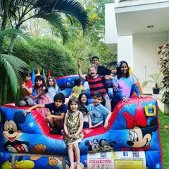 Pure party joy! A bouncy castle is always a huge hit, and this shot captures the happy energy of a group of friends celebrating together at a fun-filled birthday bash.