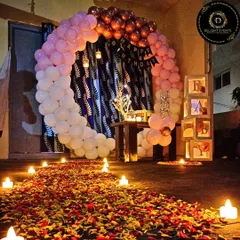 This is one of our popular romantic home birthday setups. It features a circular balloon arch, a "BABY" block display, and soft candlelight to create a cozy and intimate atmosphere perfect for a surprise celebration.