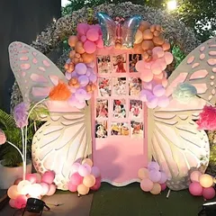 The centerpiece of this party was a stunning photo booth featuring giant, illuminated butterfly wings and a personalized photo grid, perfect for creating lasting memories.
