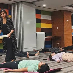 Walking through the room with a frame drum during a corporate session. The drum's rhythmic, grounding beat helps to anchor the participants' awareness in the present moment, quieting anxious thoughts.