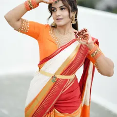 Another shot from the same series, where the simple henna design on the back of her hands perfectly matches the festive and bright colors of her outfit.