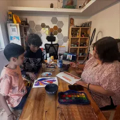 An instructor provides one-on-one guidance during a watercolor session. We ensure every child gets the personal attention they need to develop their technique and confidence.
