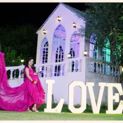 Our versatile chapel set is perfect for creating elegant and dreamy maternity portraits. The flowing gown and grand backdrop come together for a timeless photo, and our large 'LOVE' prop adds a special touch to celebrate your growing family.