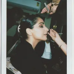 A candid polaroid of Sonam Kapoor in the makeup chair, getting ready for her shoot in the Rimzim Dadu metal saree.