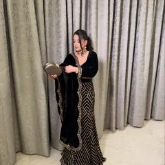 The full look for Shreya. Her black velvet outfit is complemented by a sophisticated makeup look.