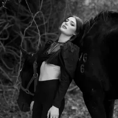 A black and white portrait of a model with one of my horses, showcasing the gentle and calm nature of my animals even during a busy shoot.