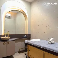 This is one of our serene and private treatment rooms at our Ahmedabad location. The minimalist design, soft lighting, and dedicated sink area create a perfect environment for you to switch off and enjoy your facial.