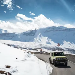 An off-road vehicle navigates a winding road in the snow-covered expanse of Spiti Valley. This drone shot captures the scale of the Himalayas and the spirit of adventure that drives me to explore these remote landscapes.