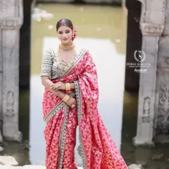 A model looking stunning in a pink floral Navvari saree, complete with traditional gold jewellery. This is a perfect look for a Maharashtrian bride.